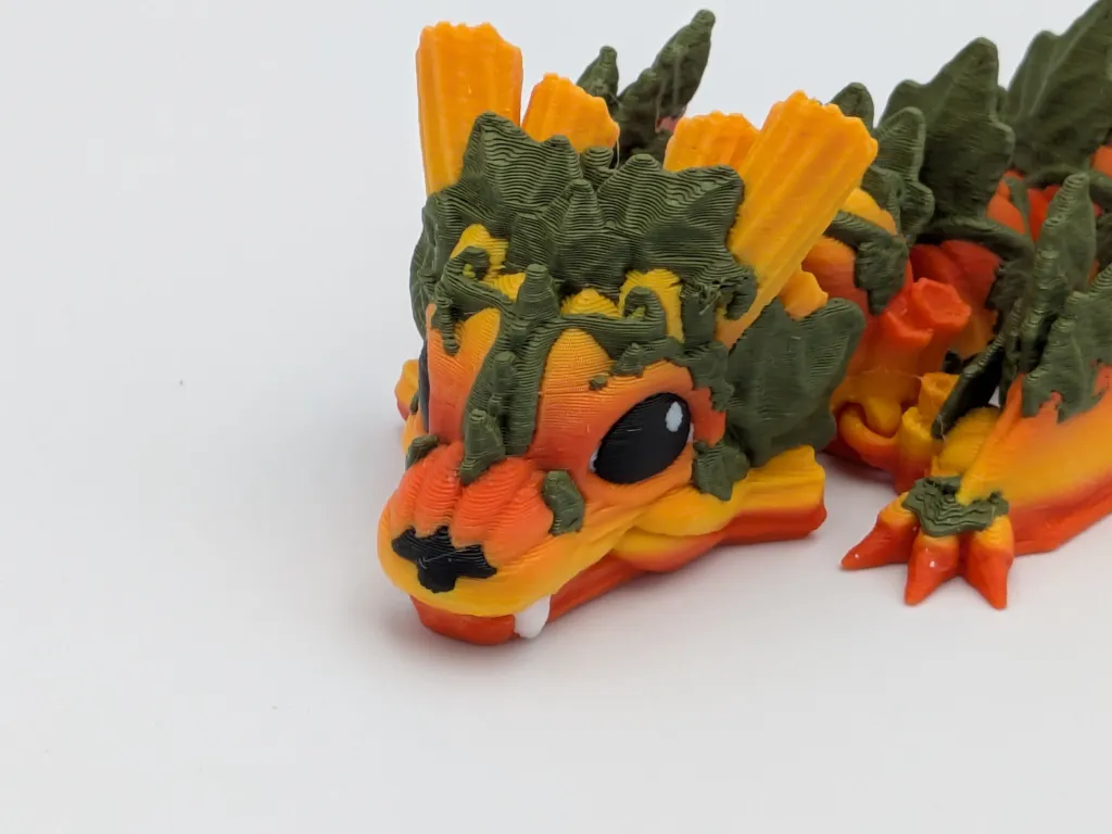 Orange and green articulated 3D-printed creature