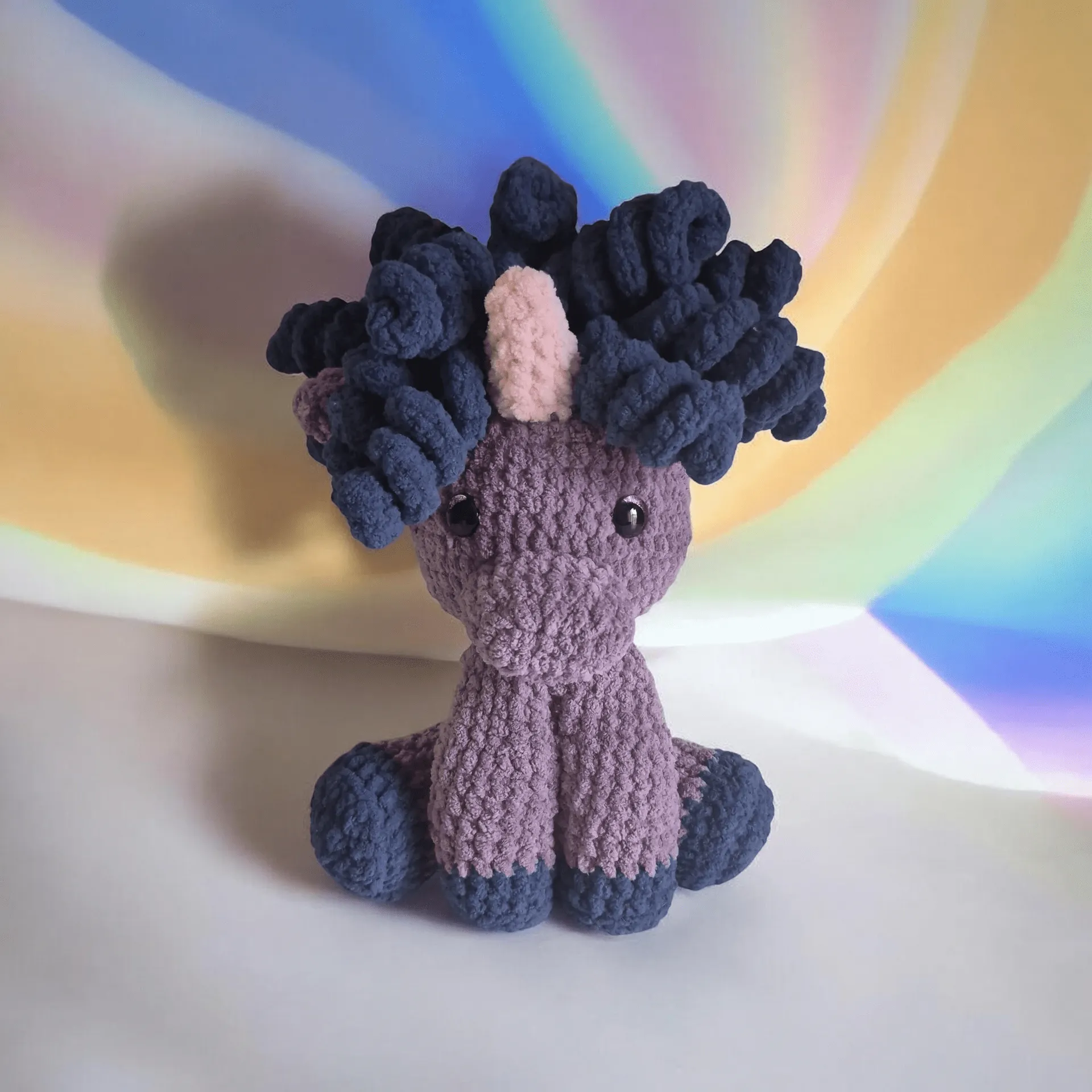 Rainbow-backed crocheted unicorn