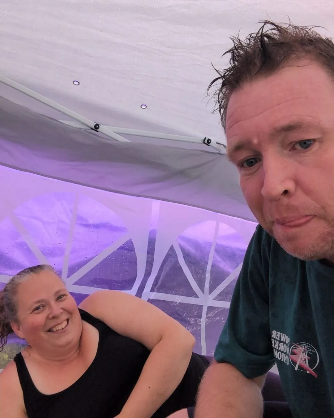 Ashley White and Jacob Campbell together beneath their market tent